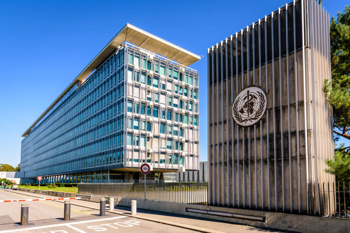 Shot of a World Health Organization building located to the right of another unidentified building.